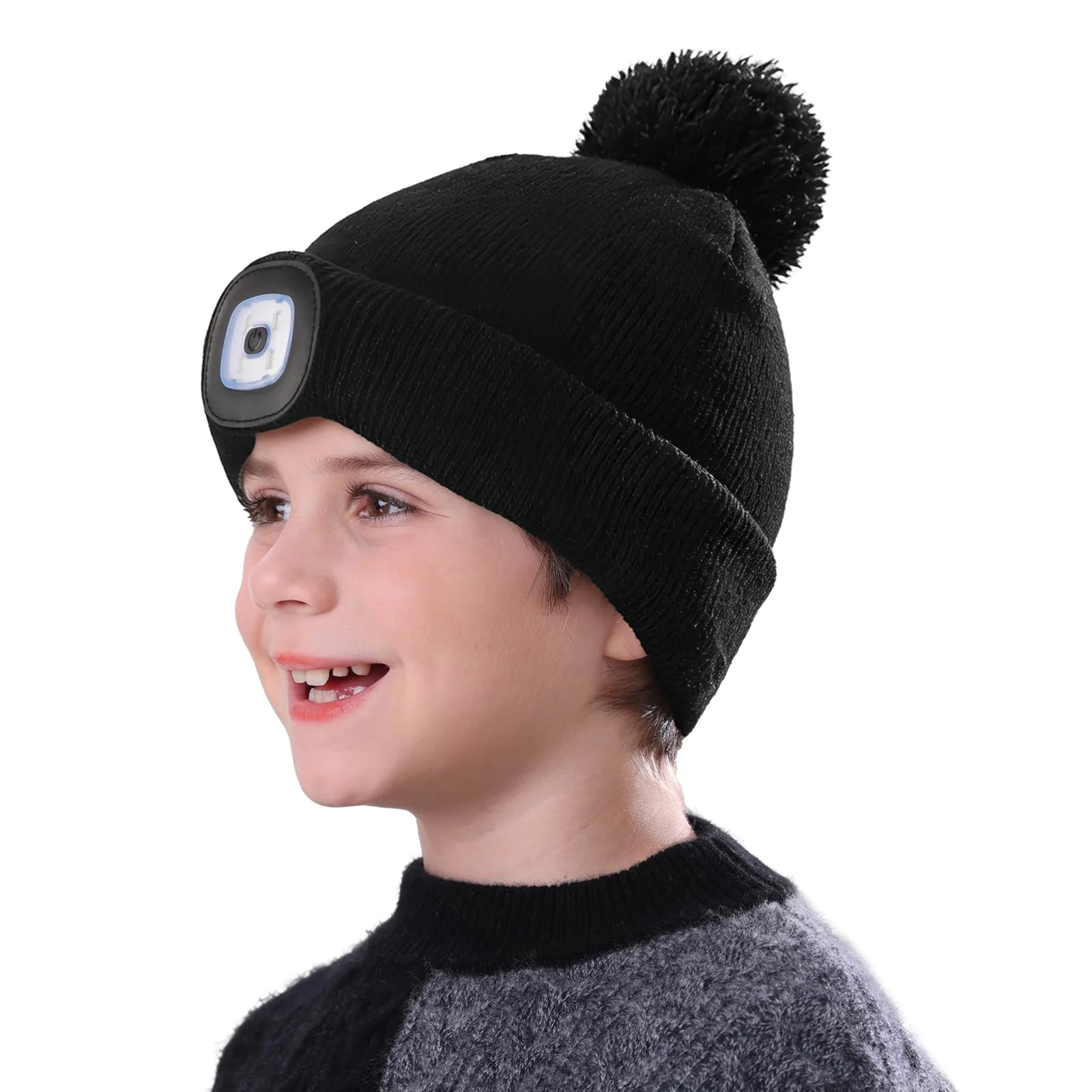 A child in a black MELASA LED beanie with a pom-pom, the light at the front of the cuff